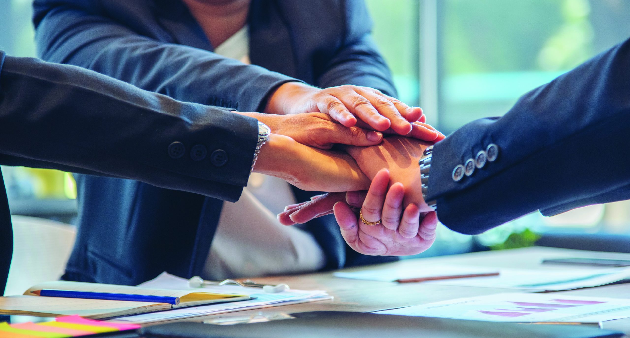 Teamwork business suit hands in stack Teamwork business suit hands in stack